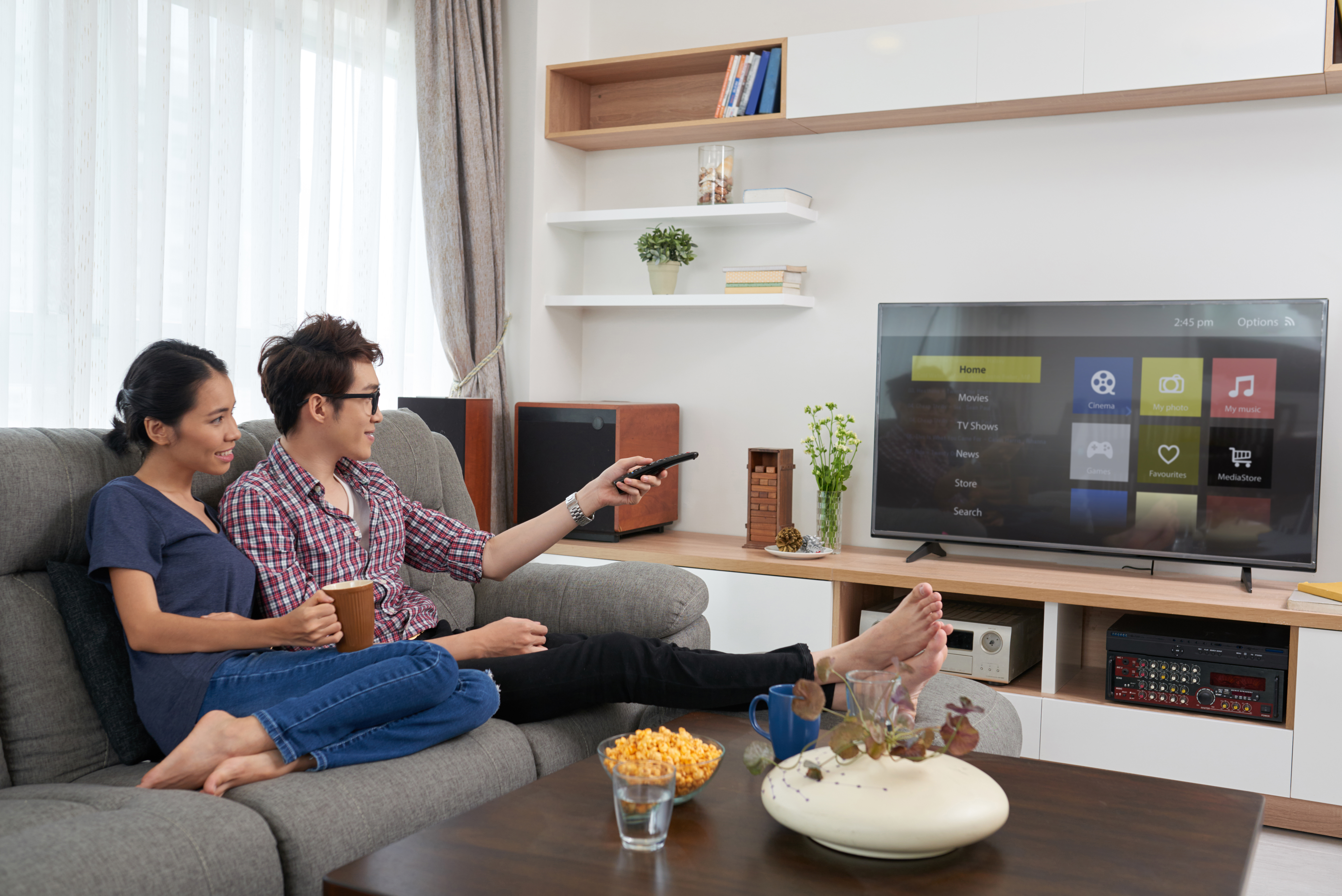 Man and woman scrolling on smart TV