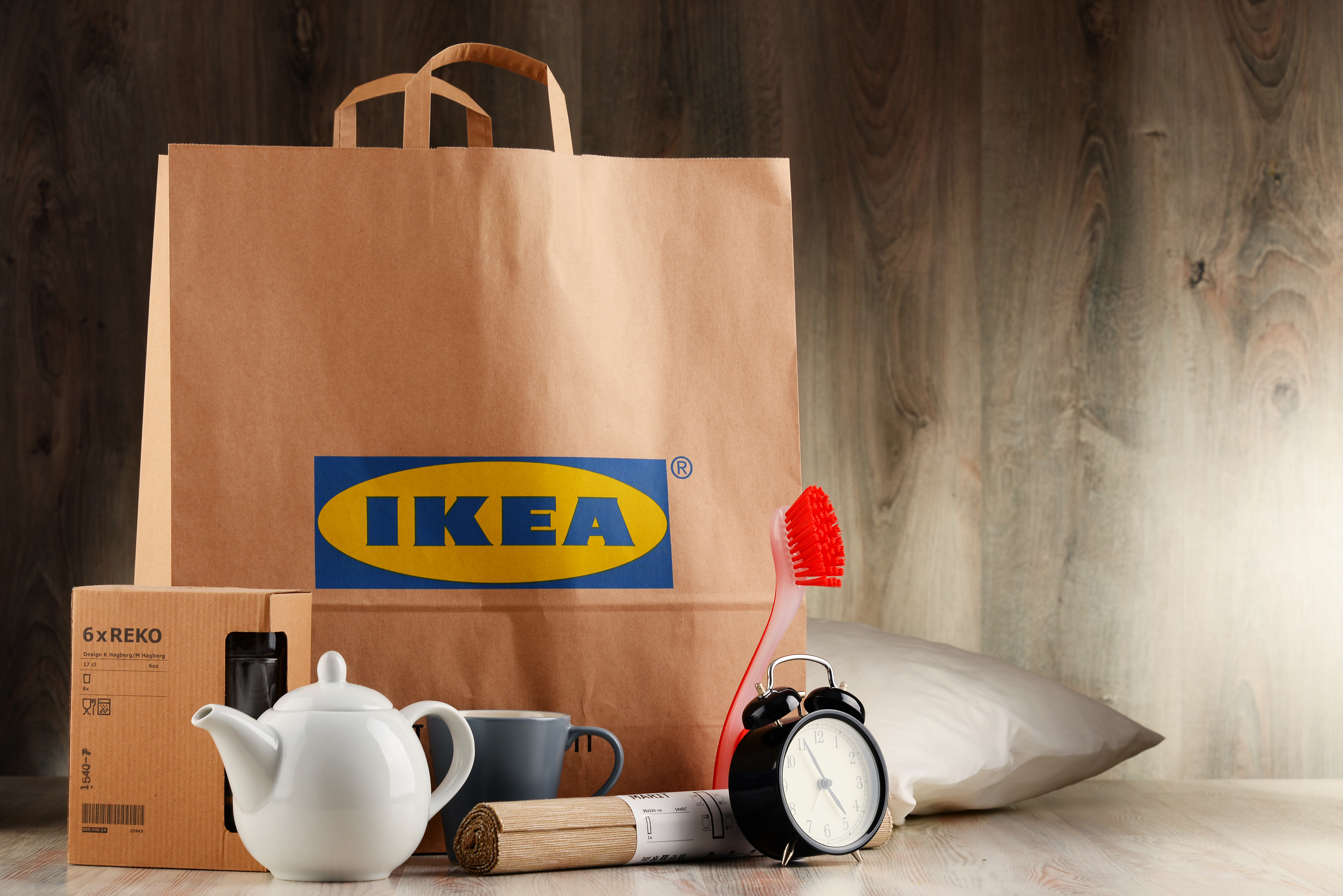 Paper bag with the IKEA logo on it next to a collection of household items
