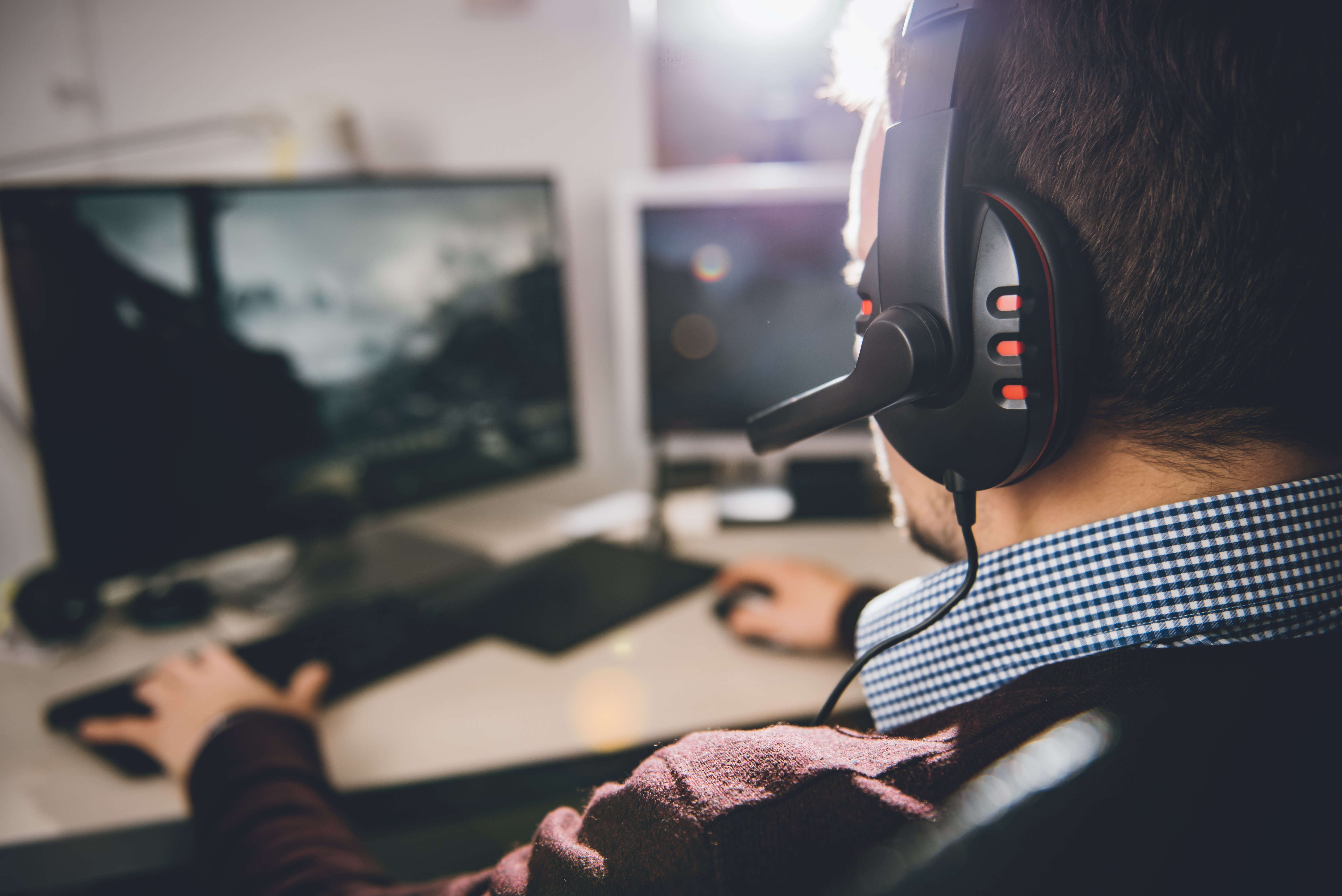 Man wearing a gaming headset playing video games