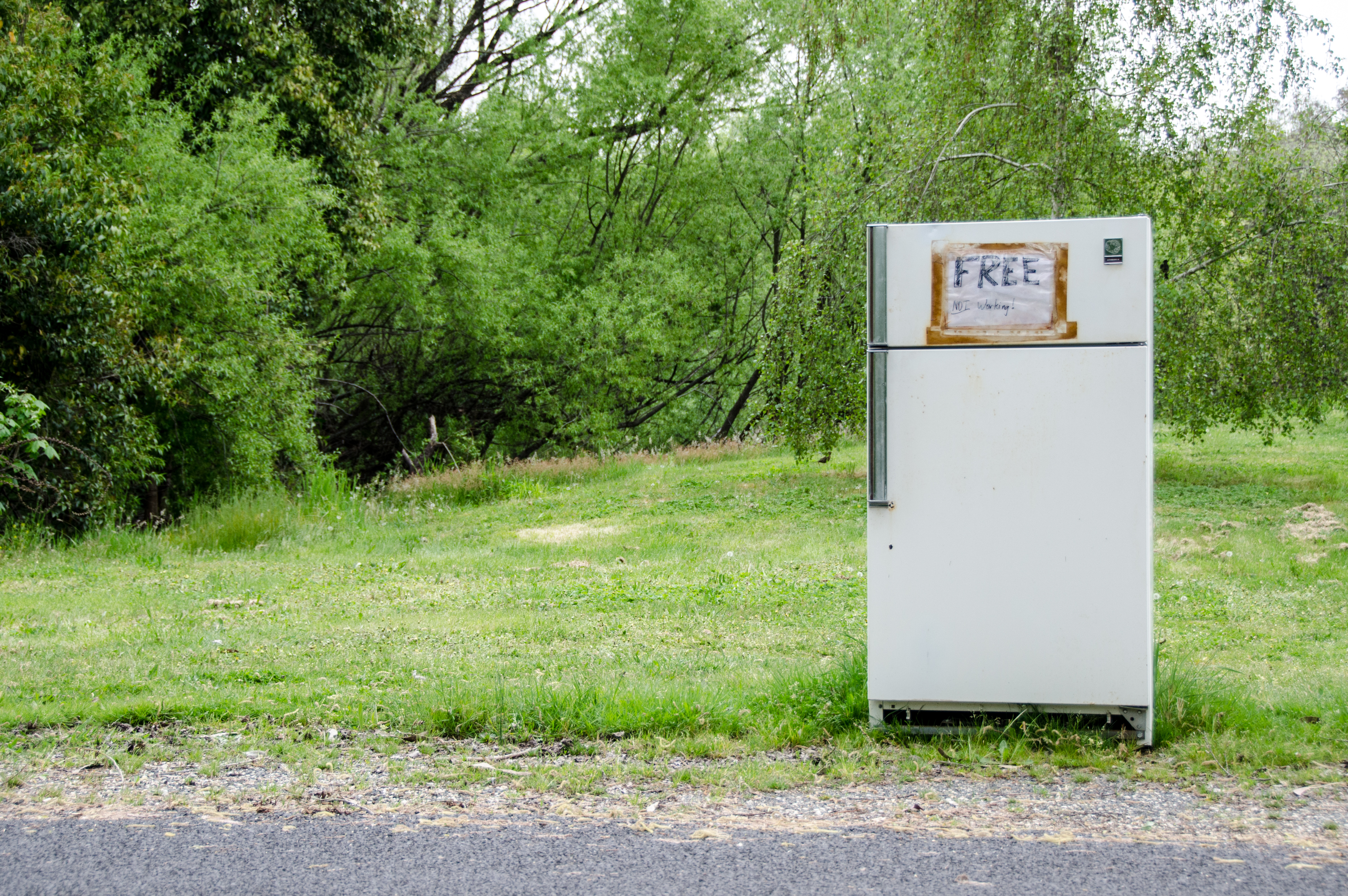 old refrigerator on the side of the road