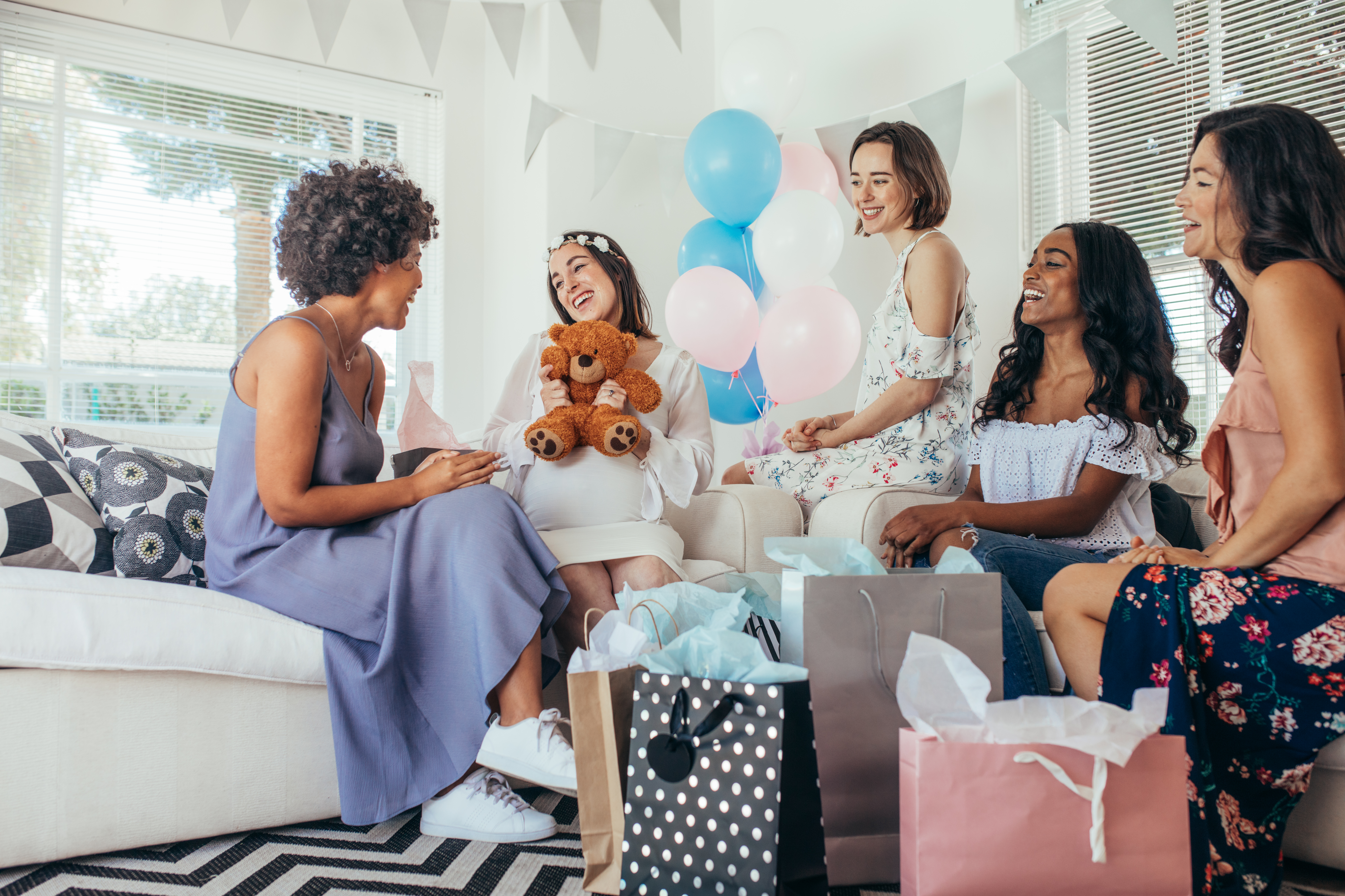 Women at a baby shower with gifts
