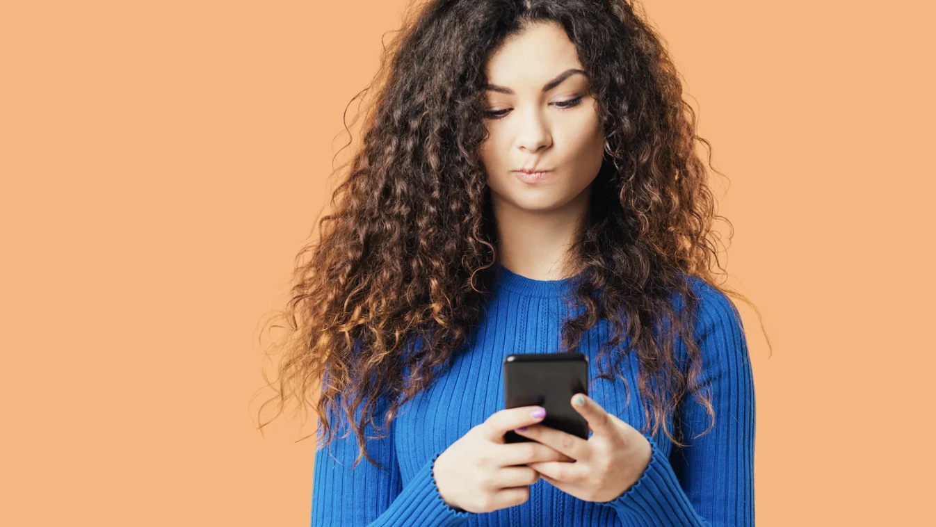 confused woman looking at phone